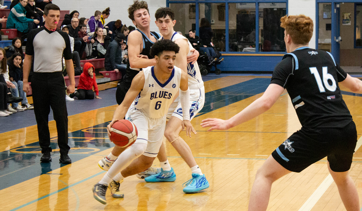 Ahmad Athman handles the ball in traffic Feb. 3 during a two-game set at home against Vancouver Island University.