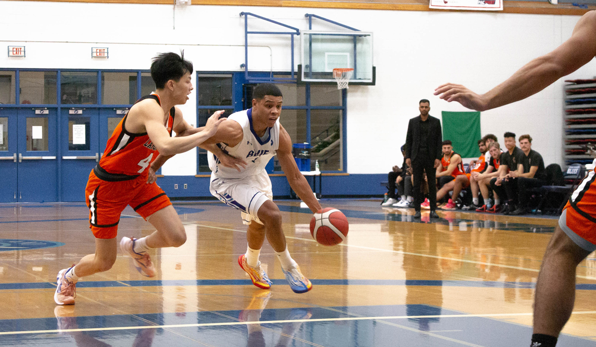 CJ Campbell brushes off a Langara defender as part of a 98-95 setback Saturday at CapU.