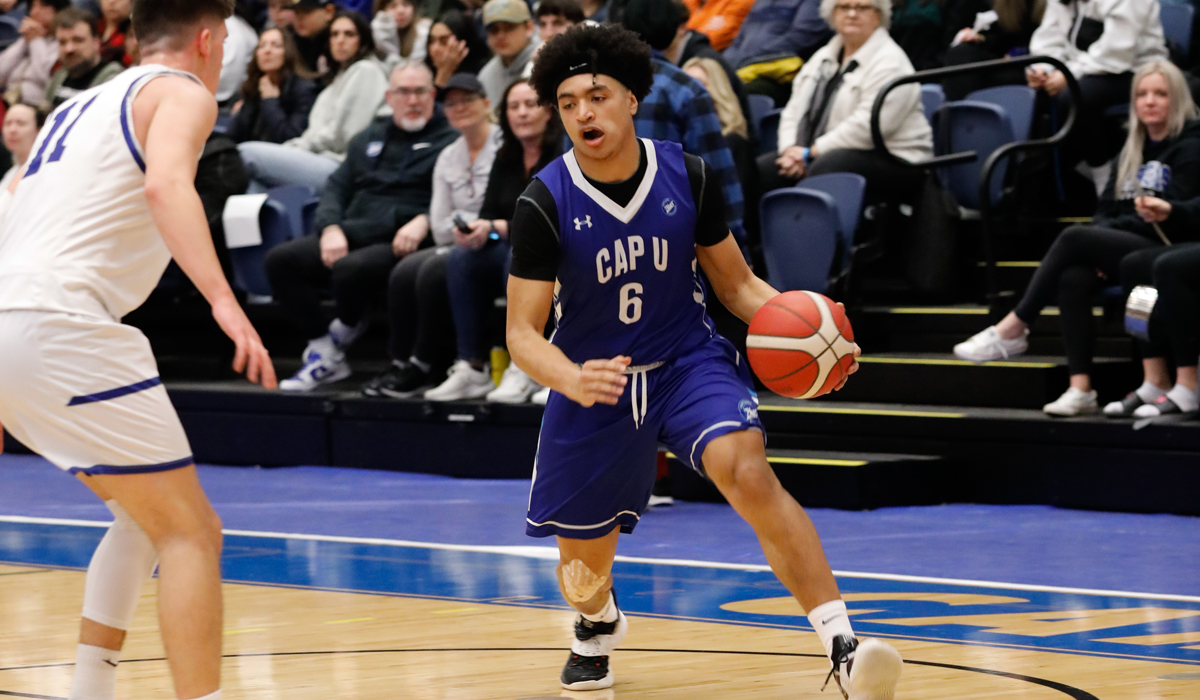 Ahmad Athman handles the ball on the perimeter Friday as part of a Blues 80-70 semifinal win over the host Camosun Chargers. (Athena Pimental photo)