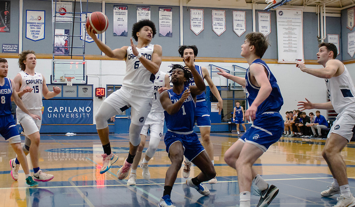 Ahmad Athman gets airborne inside a pack of Camosun defenders during a 58-57 Blues loss Dec. 1 to the Chargers.