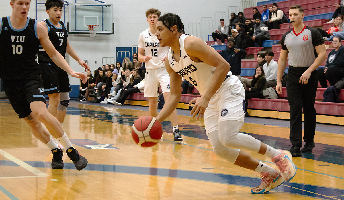 Ahmad Athman directs the Blues offence Jan. 19 during a 75-56 loss to visiting VIU.