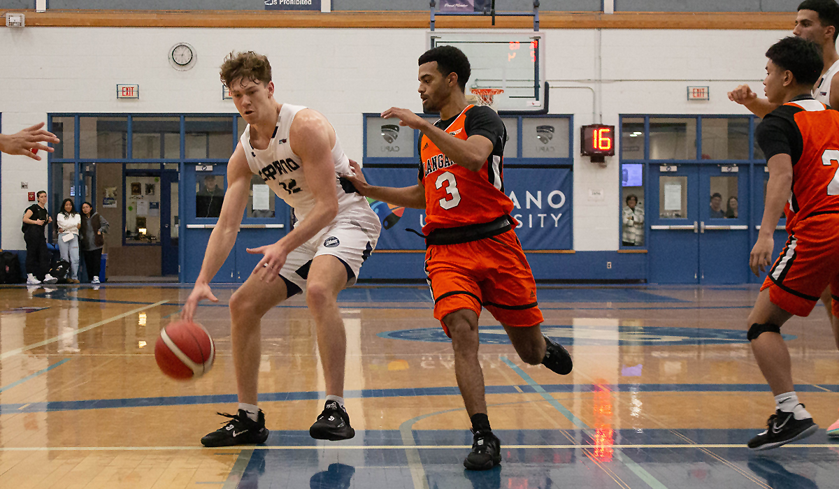 Blues guard Kash Lang handles the ball in traffic during Friday's 109-87 opening-night win over Langara College.