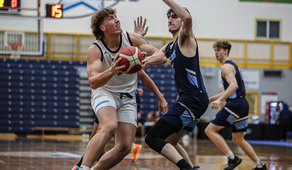 VIU's Breandan McLaughlin works in the paint against Blues centre Zach Klim as part of a 92-81 VIU win Thursday, Oct. 26 (photo courtesy Matt Carter/VIU Athletics)