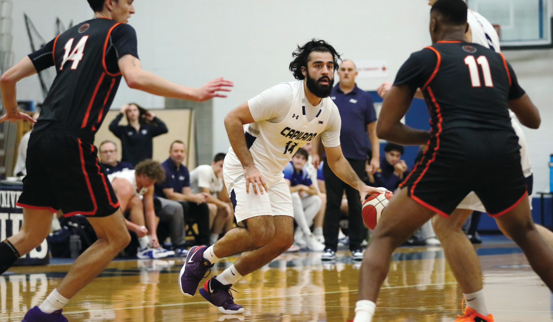 Sukhraj Garcha handles the ball on the perimeter as part of a crazy 99-94 home win over Langara Nov. 6 (Braeden Yu photo)