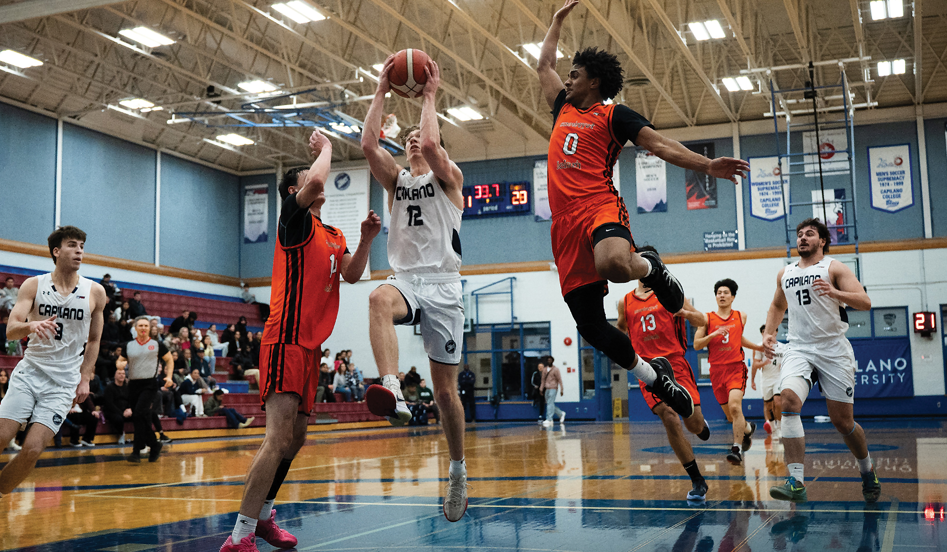 Kash Lang (12) played his final home game on Senior Night Feb. 21 at CapU, and scored 14 points with five boards to help the Blues to a 72-68 over Langara. (Chris Raeside photo)