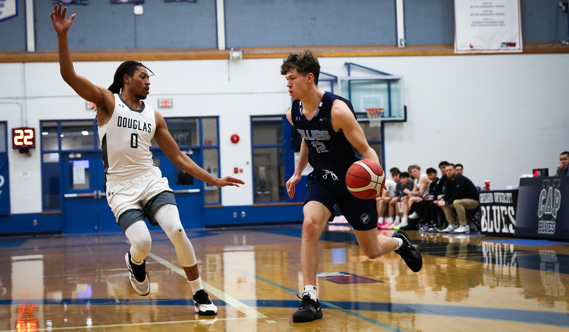 Kash Lang dribbles up the court fighting Douglas College Royals (Photo: Braeden Yu)