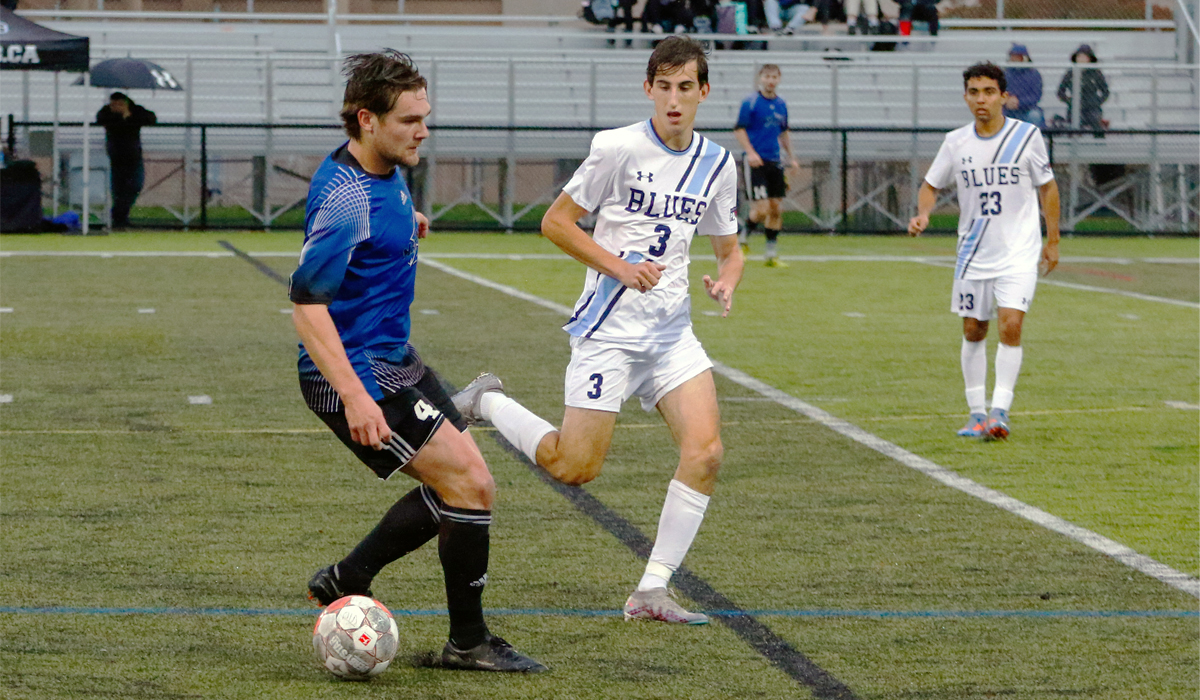 Luke Frith challenges a VIU ball carrier in Sunday's 1-0 victory over the Mariners in Nanaimo (photo courtesy Matt Carter/VIU Athletics)
