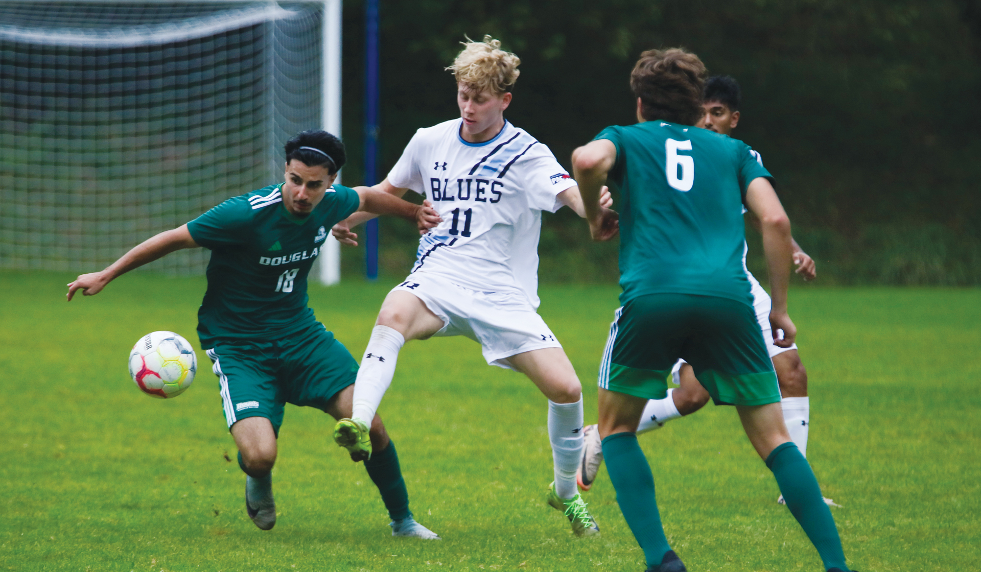 Zach Gabrys jostles with a Douglas College defender during a 2-0 loss Saturday, Sept. 27. (Braeden Yu photo)