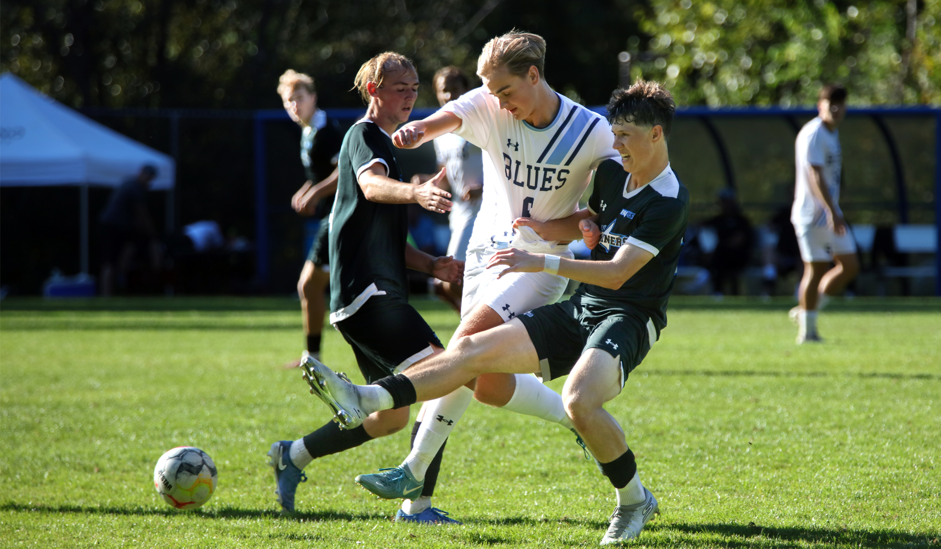 Capilano forward Campbell Grimston cuts through a pair of VIU defenders during a 2-2 draw Saturday, Sept. 13 at CapU's Lillooet Park. (Braeden Yu photo)