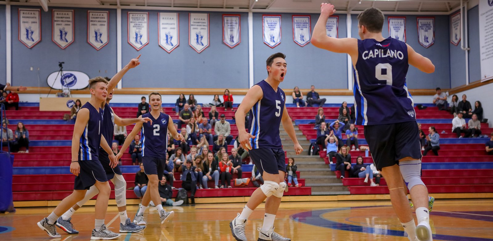 The Blues react to a kill by Capilano's Jacob Hopkins. Photo Paul Yates / Vancouver Sports Pictures