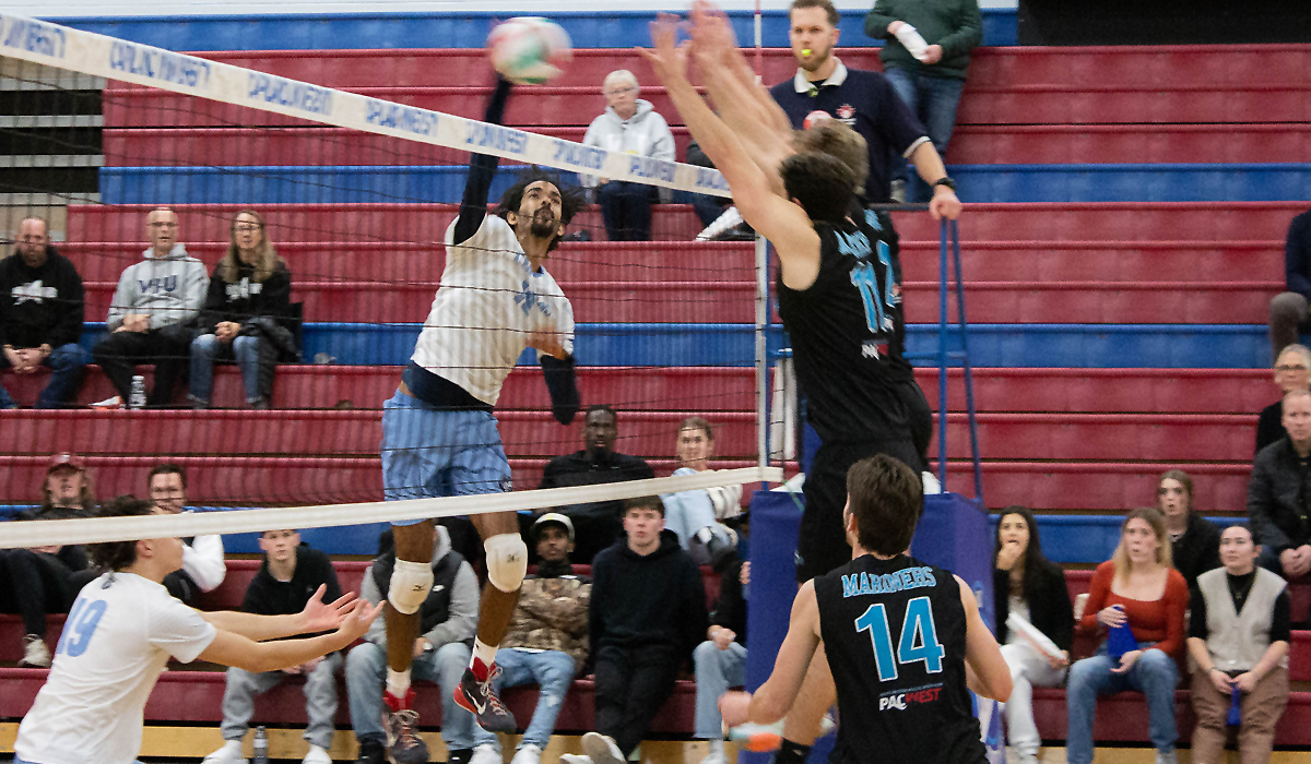 Dario Pereira unloads a big swing against a VIU tandem block Friday, Nov. 17 at CapU.