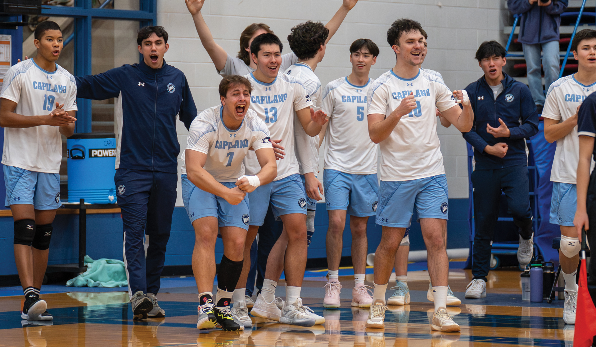 The Capilano Blues' bench reacts to a point during a straight-sets win Friday, Nov. 14 over the visiting VIU Mariners. (Chris Raeside photo)