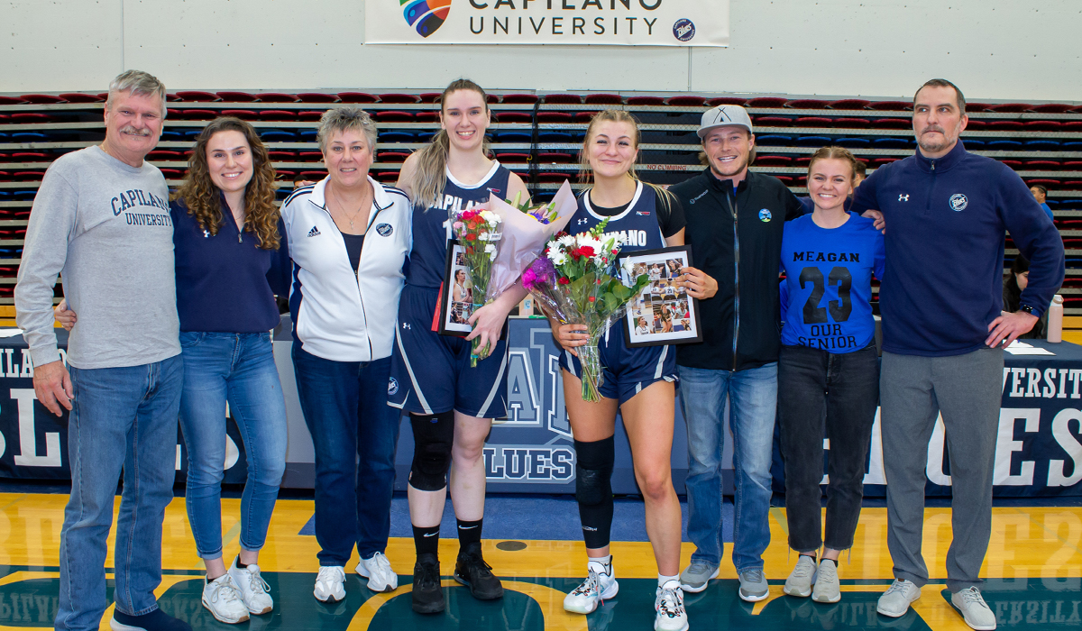 Graduating seniors Mackenzie Smith (centre left) and Meagan Briggs (centre right) led the way offensively for the Blues in their final home game at Capilano.