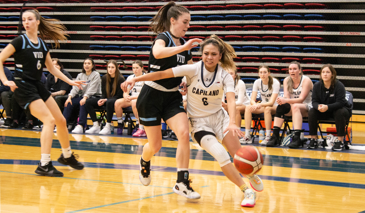 Kirsten Abo drives on VIU's C.J. Buckley. The two guards were on fire Friday with Abo scoring a career-high 40 with Buckley dropping 30 for the visitors.