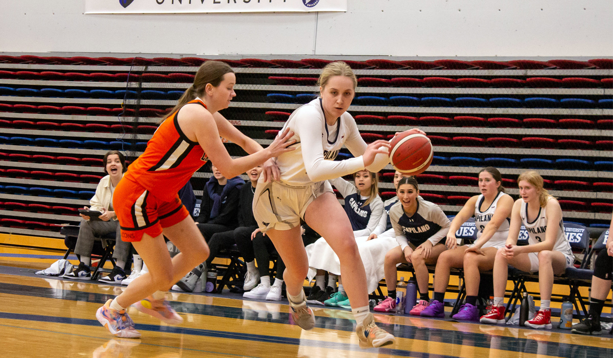Blues forward Maddie Coffin drives to the hoop in an eventual 62-58 home loss to the Langara College Falcons.