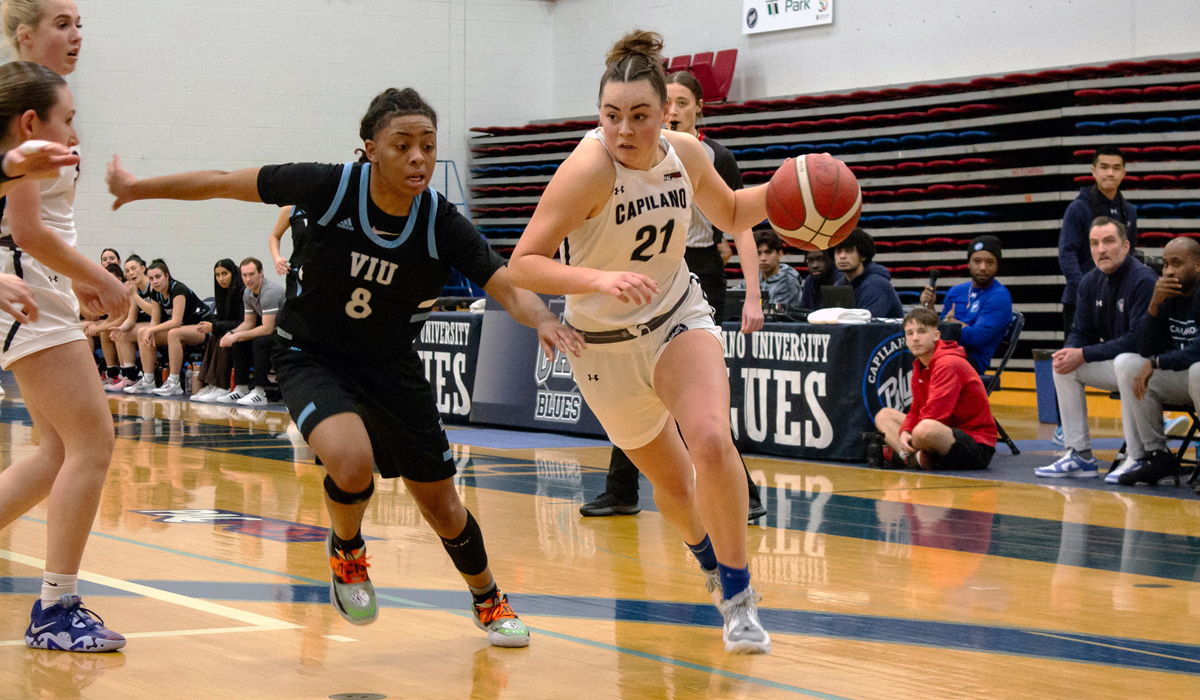 Teigan Manson drives on VIU's Makayla Kimble during a 65-57 Blues win Jan. 19.