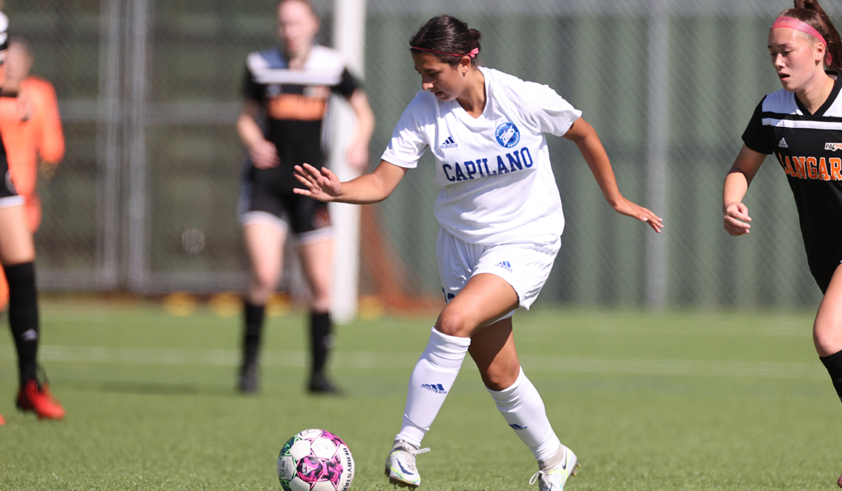 Sophie Pather controls the ball while weaving between Langara College's midfield. (Photo courtesy of Vancouver Sports Pictures)