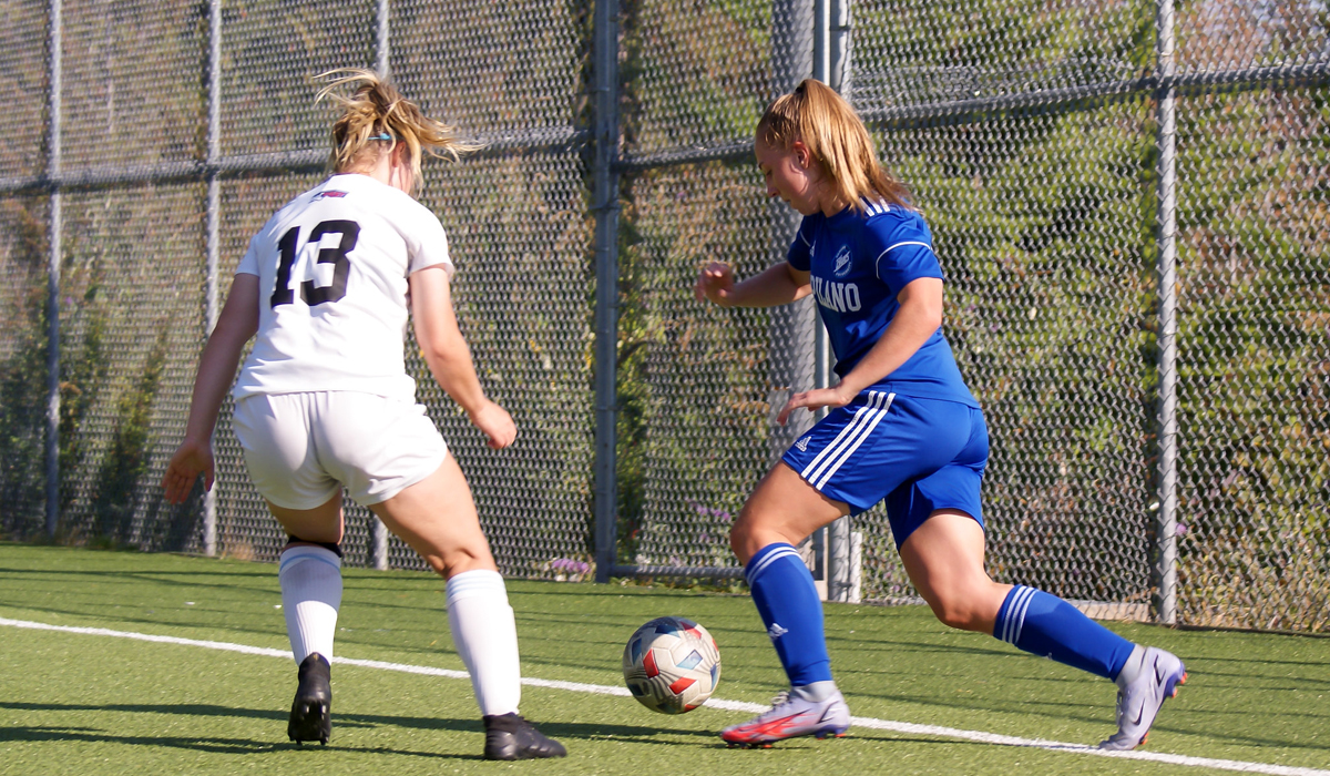 Taylor Colby works the ball up the sideline in an Oct. 2 match against visiting VIU.