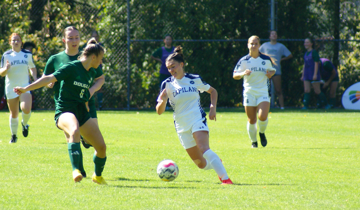Capilano's Maya Smith changes direction on a Douglas College defender during Saturday's 2-1 Blues home win.