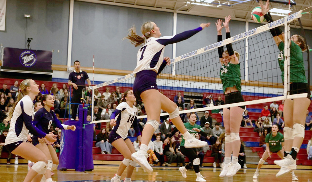 Sibby Bos blasts a kill through a double block put up by Douglas College during Friday's straight-sets home win. (Vancouver Sports Pictures)