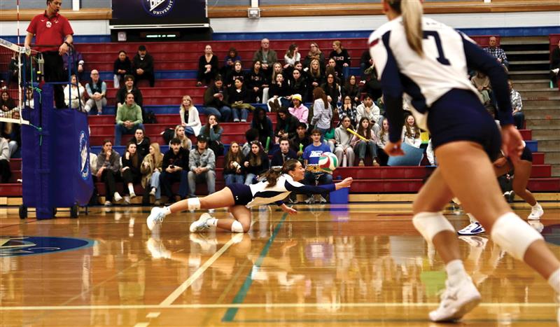 Setter Mollie English dives for a dig during a Jan. 9 straight sets win at home against Douglas College (Vancouver Sports Pictures)
